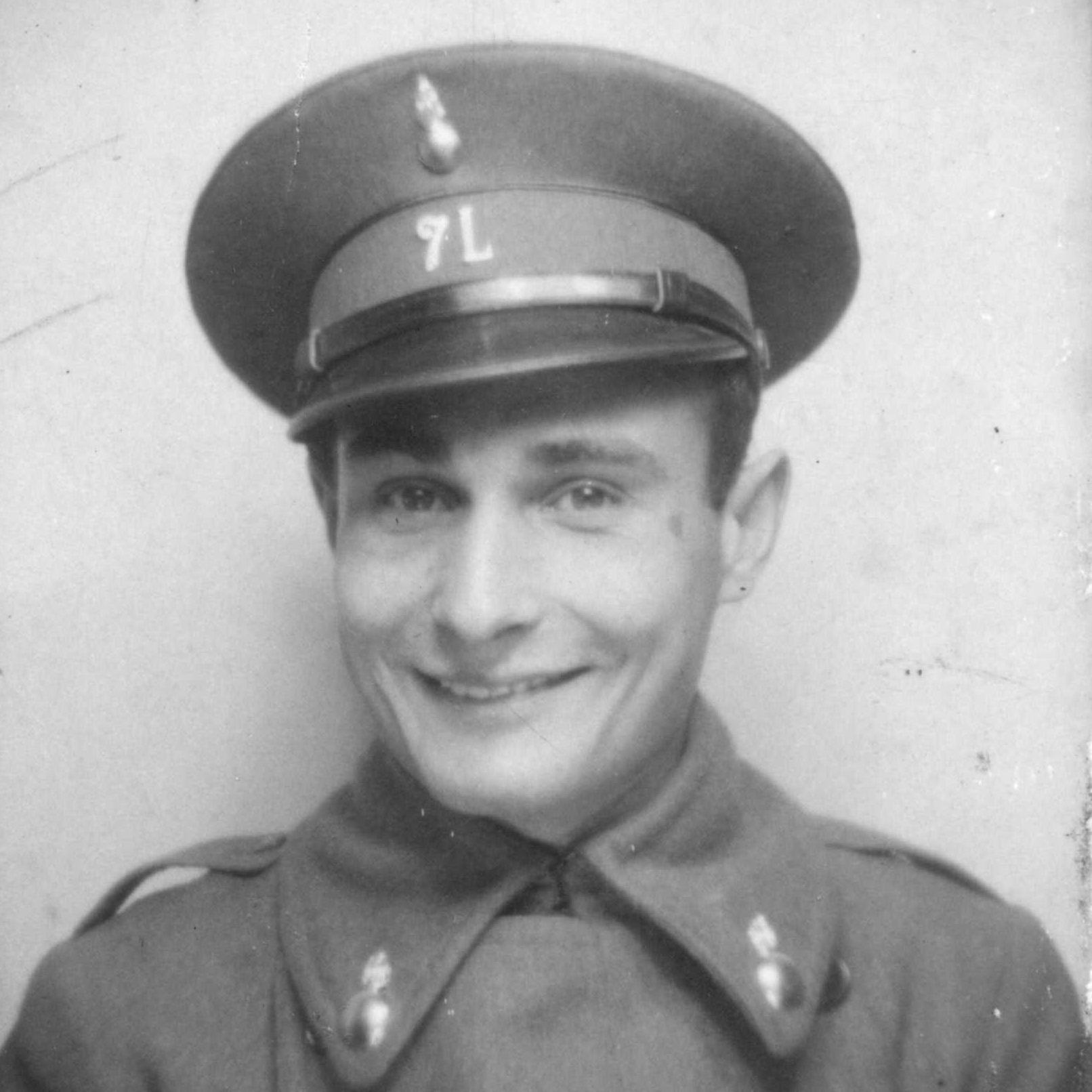 A
            black-and-white photograph of a young Juan Pujol Garcia from the shoulders up. He wears a
            military uniform, presumably from WW2.